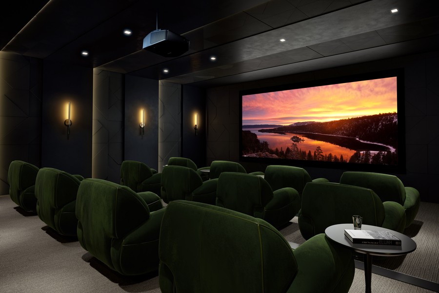 A luxury home theater setup in Whitefish featuring a large screen, plush seating, and custom sound and lighting.