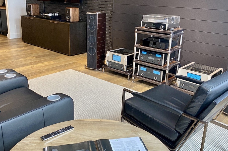 Eyehear Technology Groups hi-fi showroom featuring McIntosh, theater seats, and floorstanding speakers.  