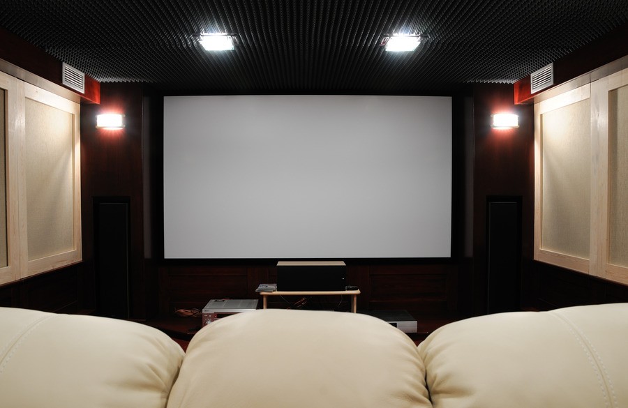 Photo of a cozy home theater with low lighting.