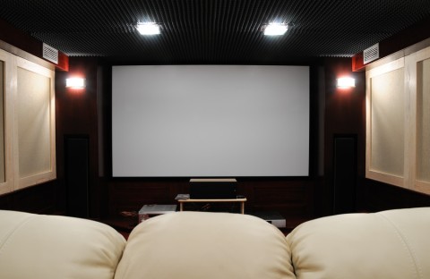 Photo of a cozy home theater with low lighting.