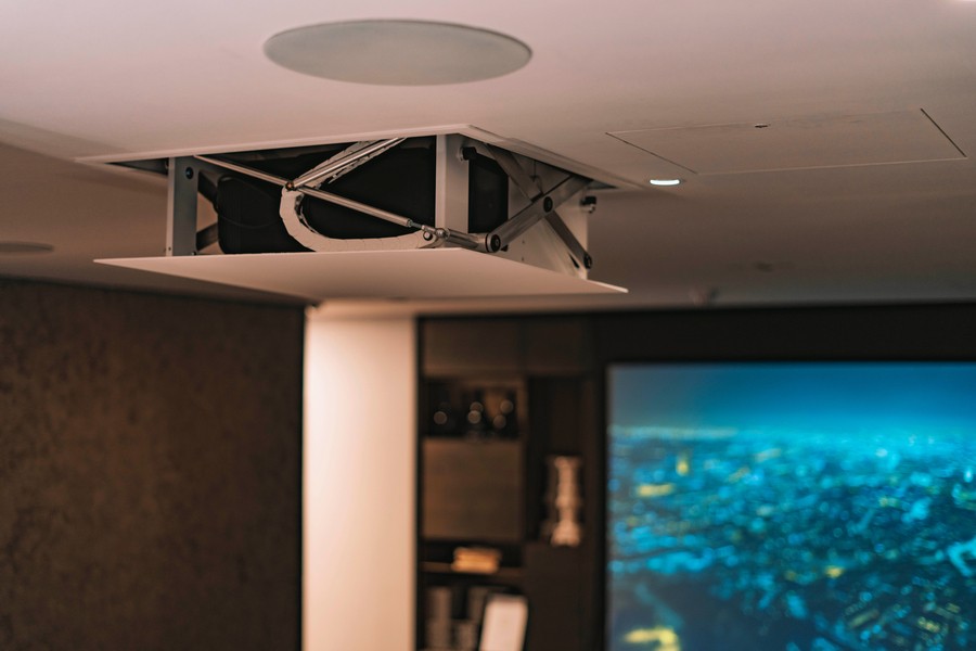 An in-ceiling projector and in-ceiling speaker hidden technology solutions. 