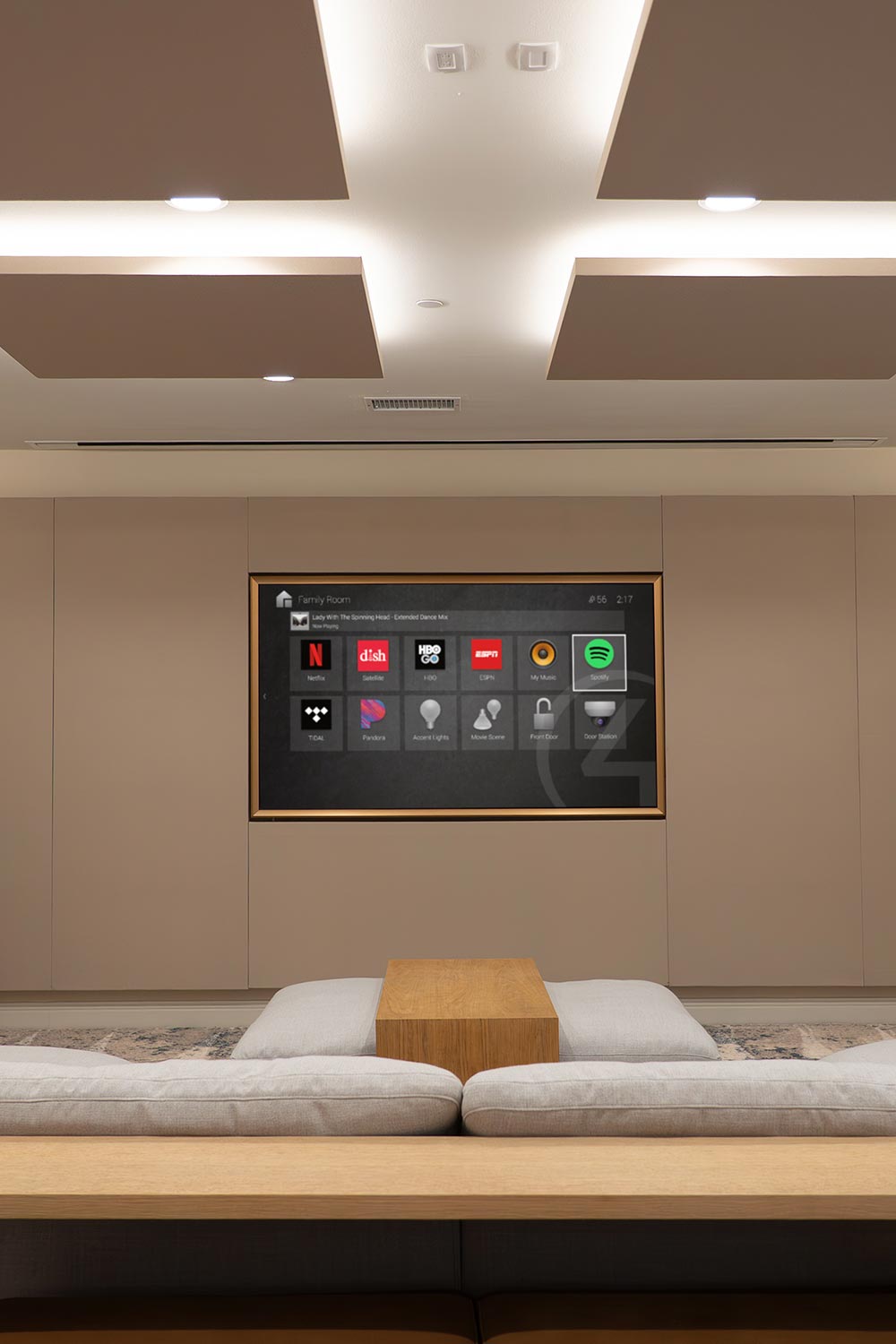 Modern home theater with flat-screen TV displaying media menu and fabric acoustic ceiling panels