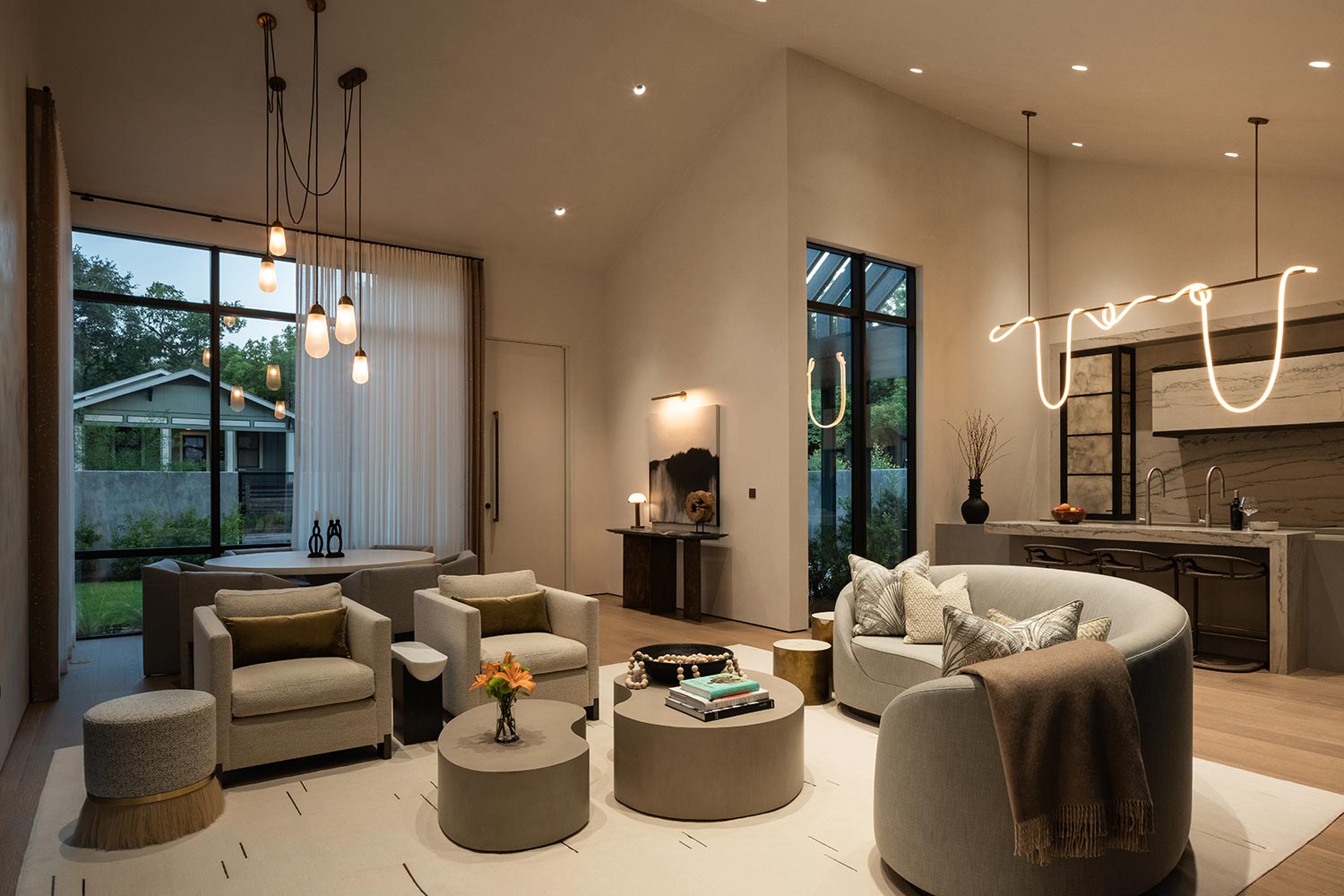 Contemporary living room at dusk with a mix of soft interior lights and fading outdoor light
