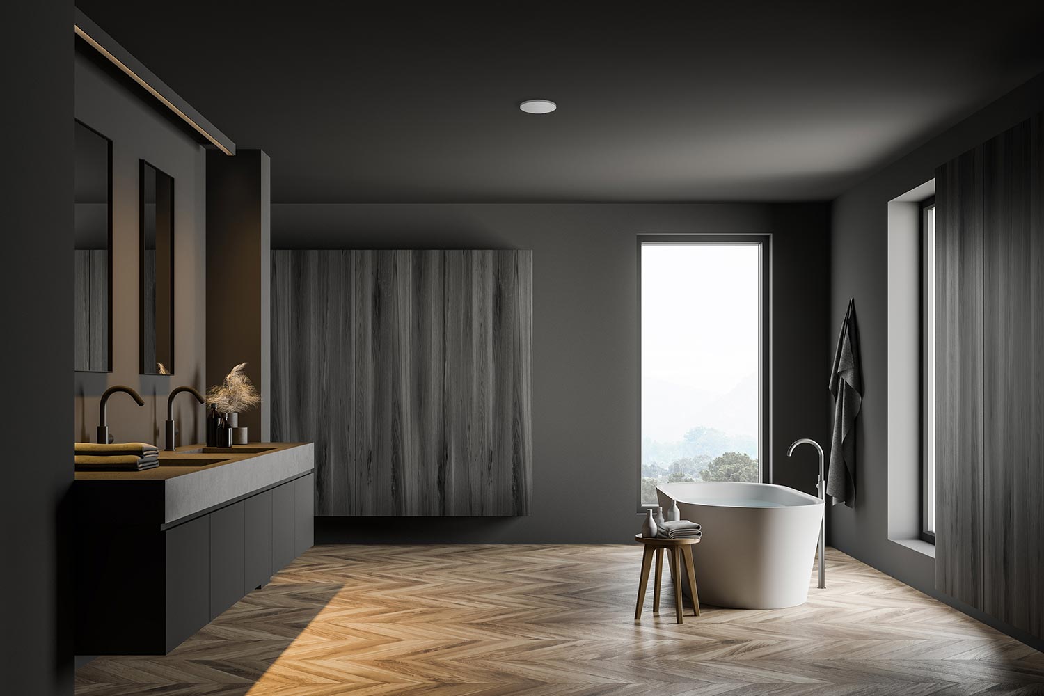 Minimalist dark gray bathroom with a freestanding tub, double vanity, and herringbone wood floor