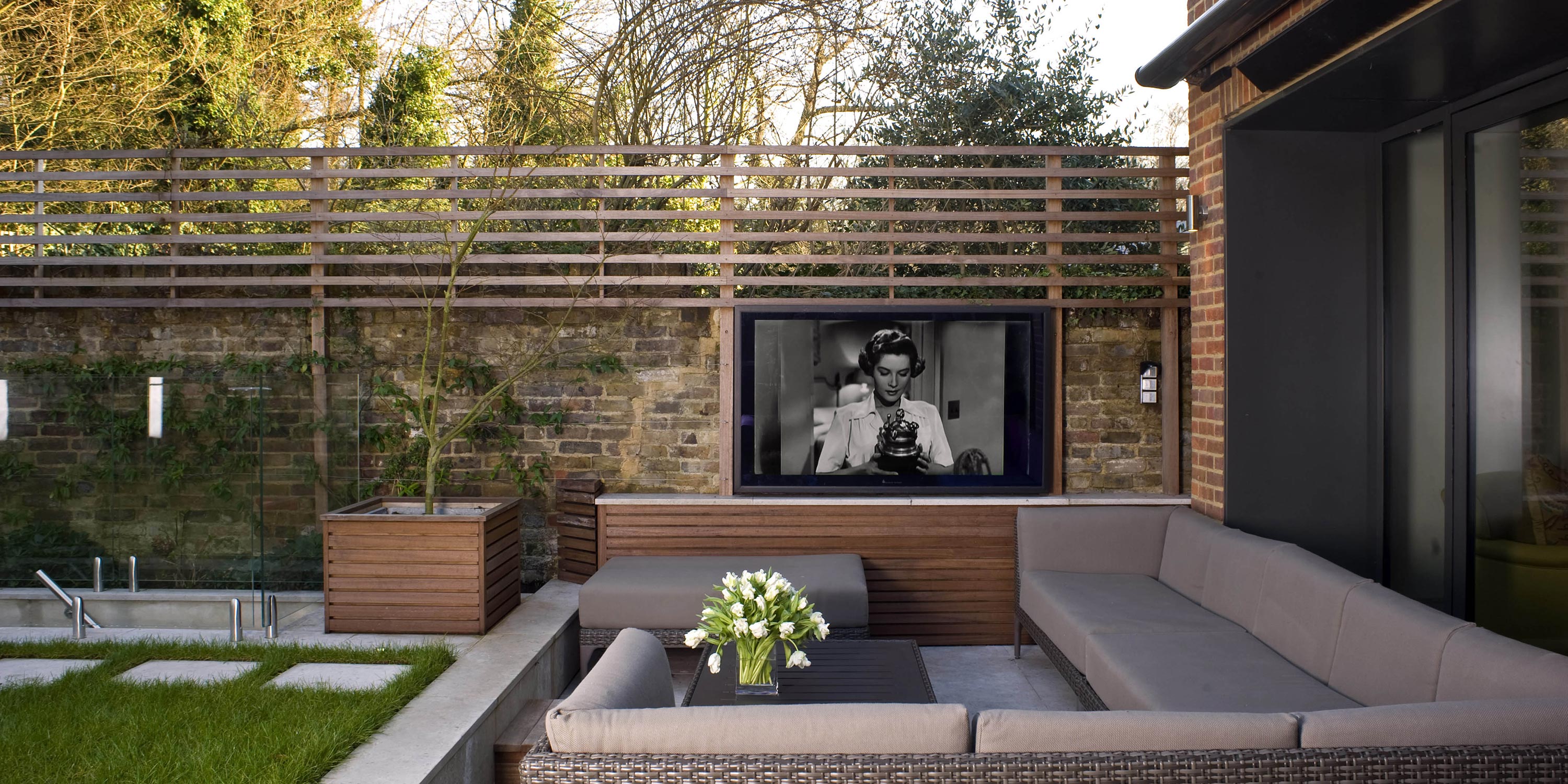 outdoor patio area with neutral colors couches