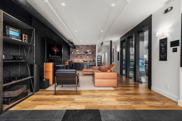 Eyehear Showroom living room with TV, speakers and suede furniture