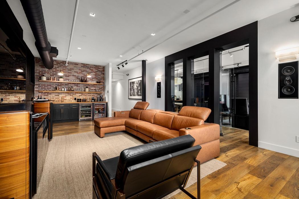 Eyehear Showroom living room with TV, speakers and suede furniture