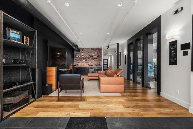 Eyehear Showroom living room with TV, speakers and suede furniture