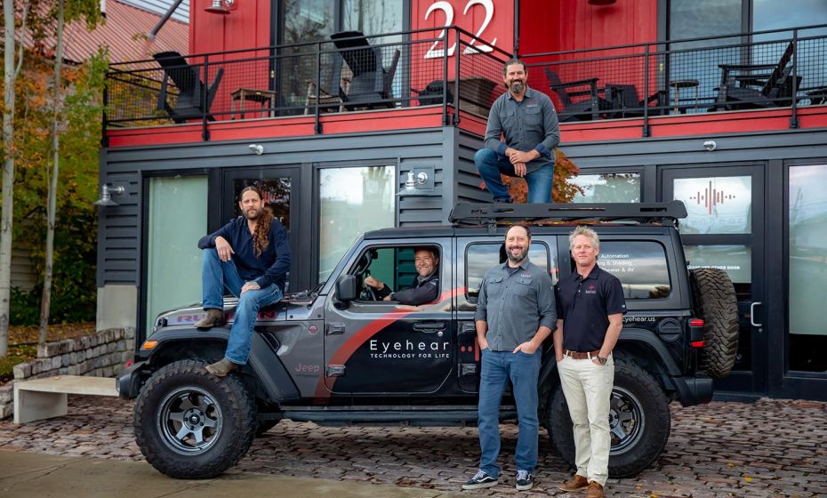 Eyehear Showroom front with a man driving a branded Eyehear truck 