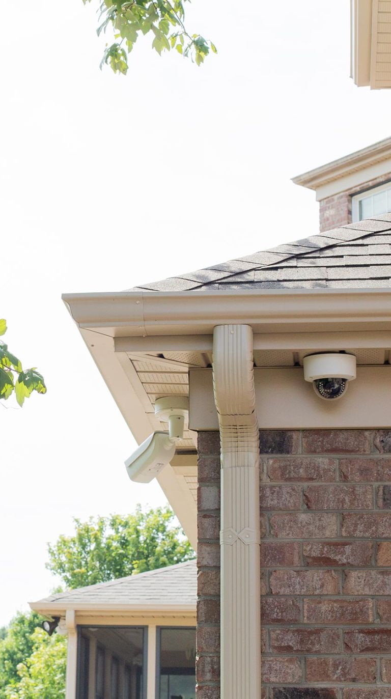 Outdoor security cameras mounted on house eaves