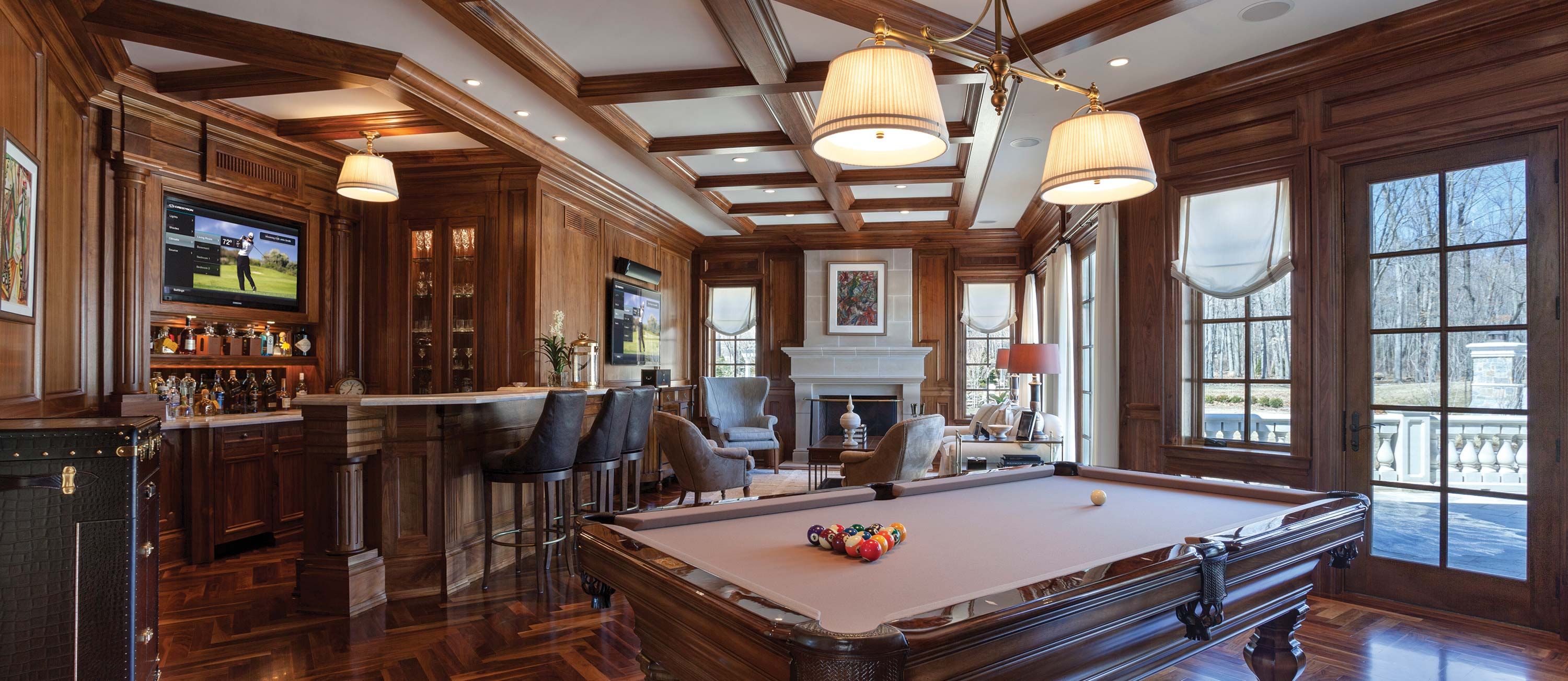 wooden bar room with pool table and crestron technology