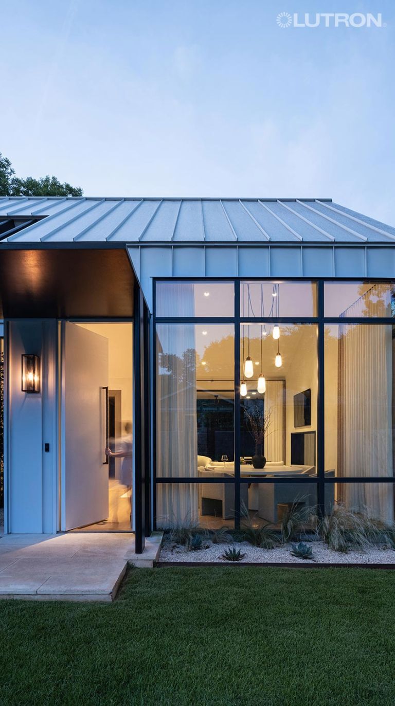 Modern home exterior with warm interior lighting