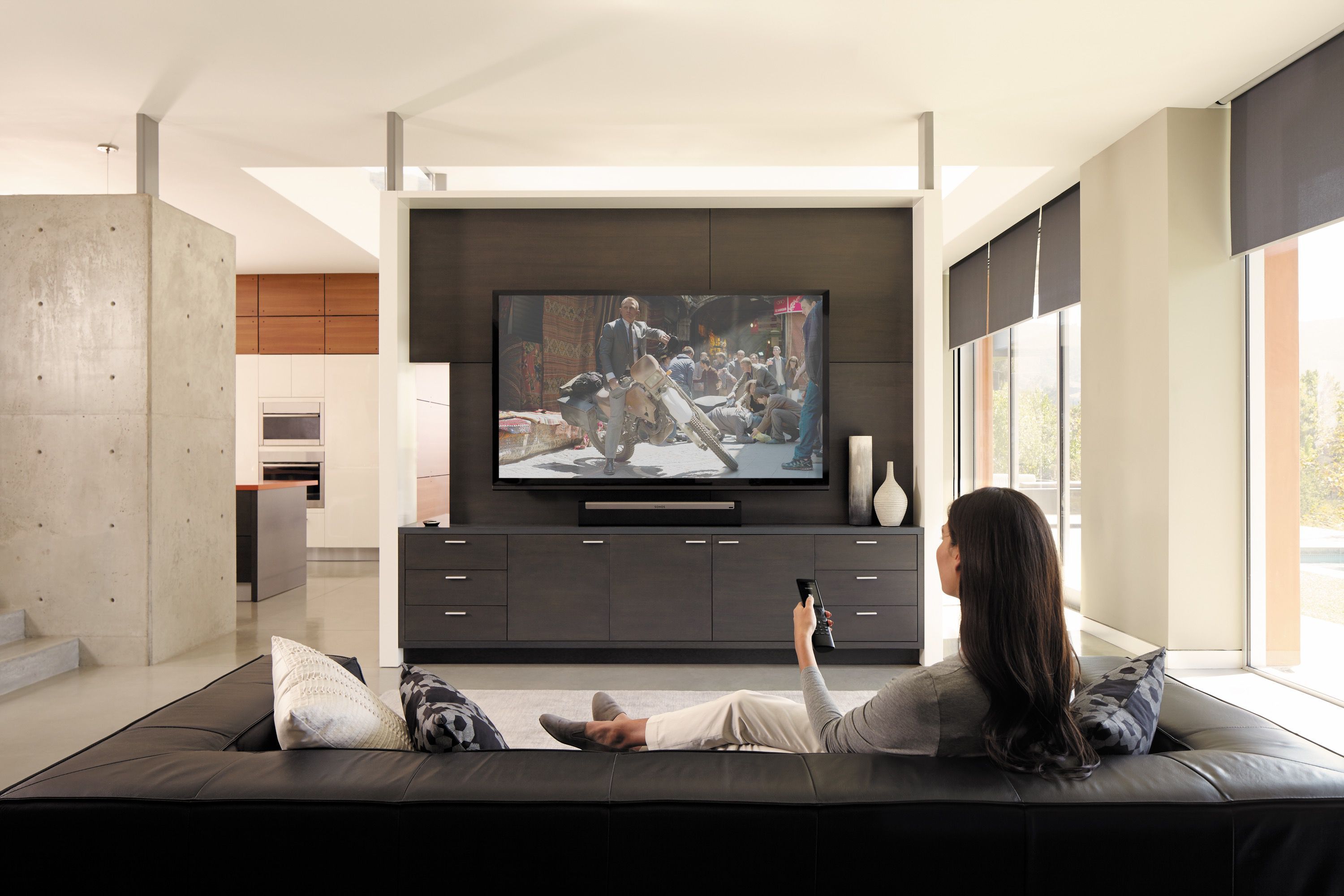 woman watching tv in modern room savant technology