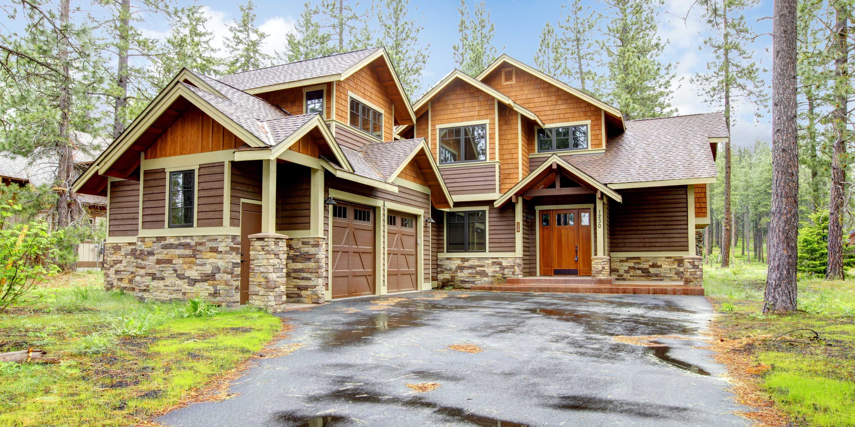 home in the woods with brown siding and wooden door